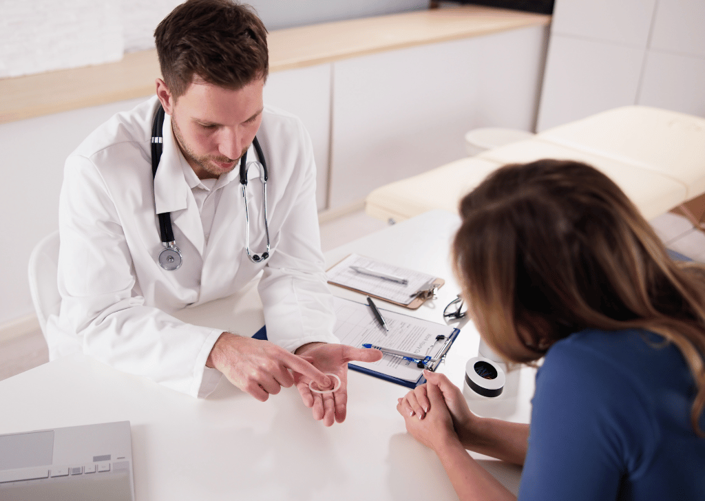Gynecologist Showing Contraception Ring To Woman