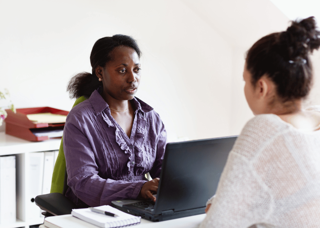 Black community health workers helping a women
