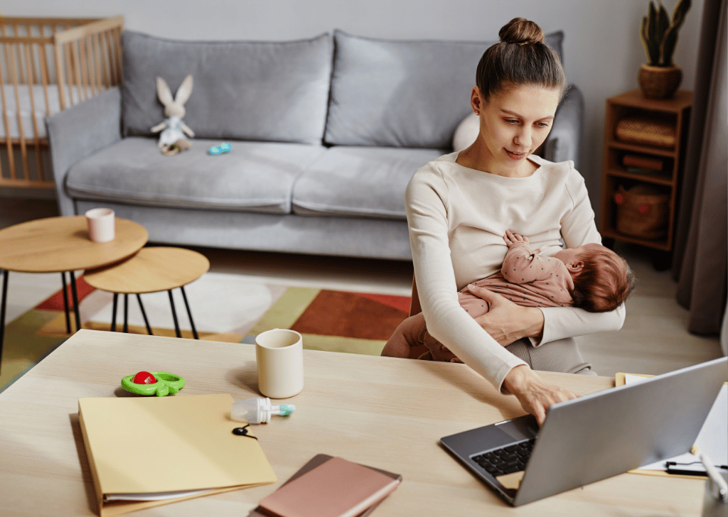 Mom working at home with a newborn breastfeeding.