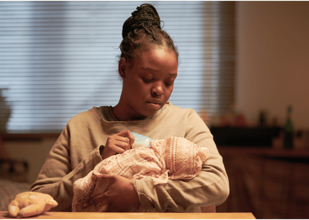 Young Black mom feeding her newborn baby