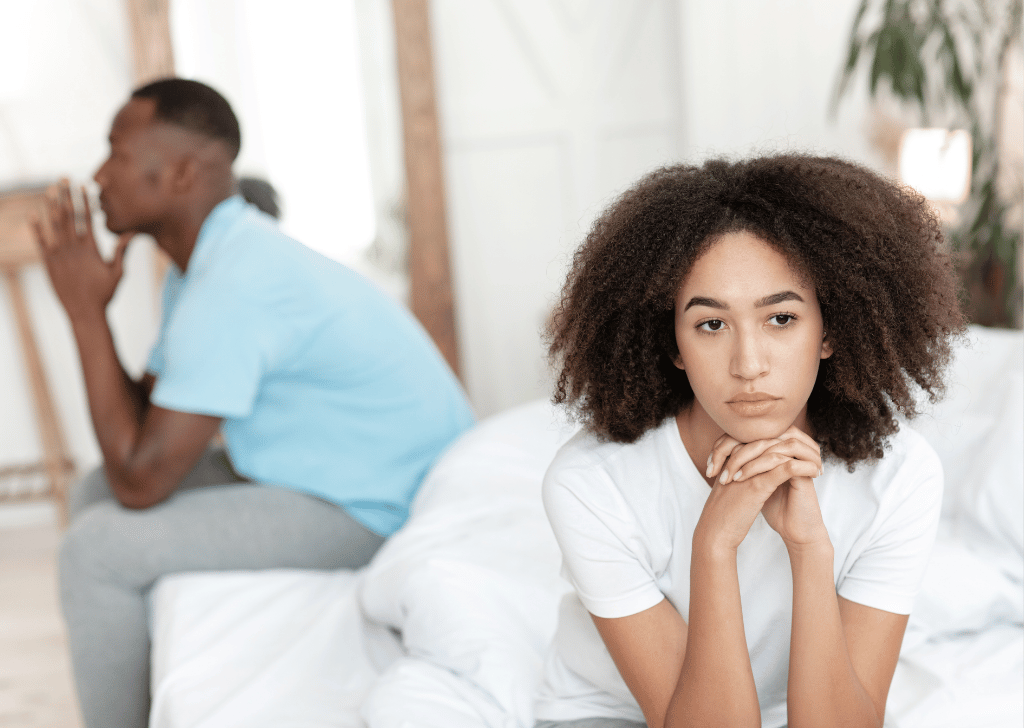 Couple ignoring each other in a bedroom.