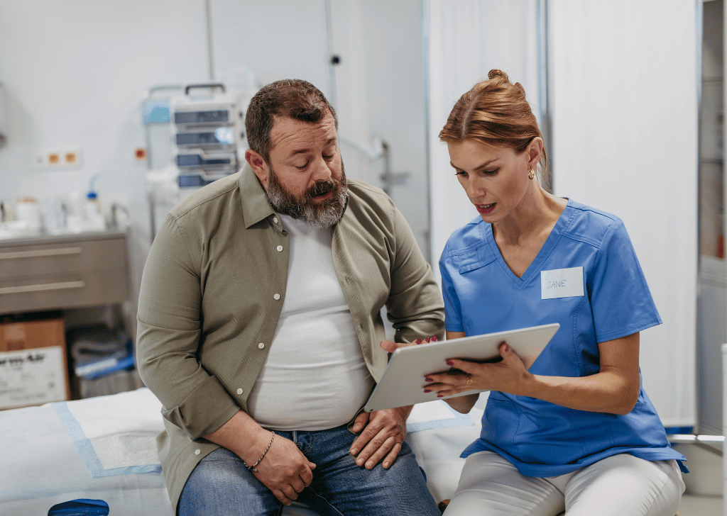 Female doctor consulting with adult male patient, discussing test results.