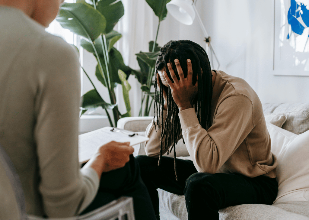 Stressed black man with dreadlocks in behavioral health office