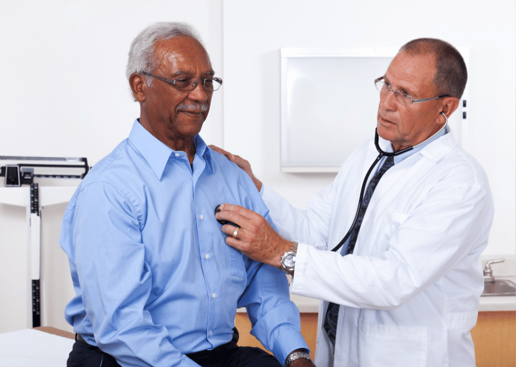 Doctor listening to the heart of a Black male patient