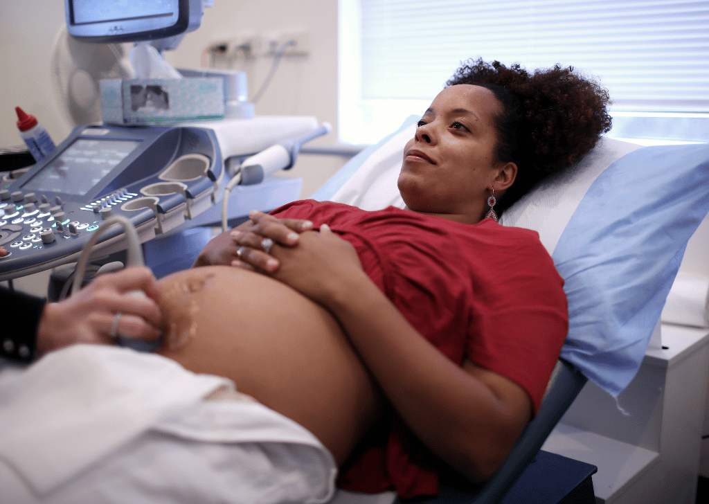 happy pregnant women In prenatal appointment